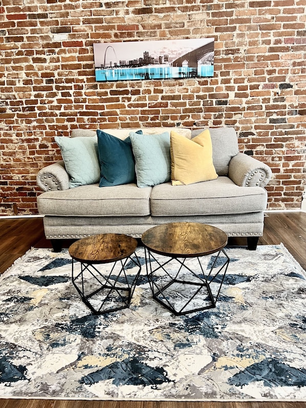 Living room with lots of natural light and comfortable love seat.