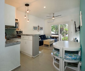 Open-concept living room. Kitchen with table for six.