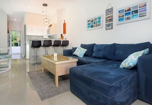 Island with 4 bar stools 2 additional stools located in 2nd bedroom storage area
