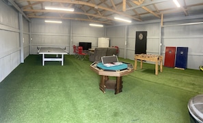 Ping pong, TV, fridge, darts, foosball, cornhole, poker/bumper pool, and more!