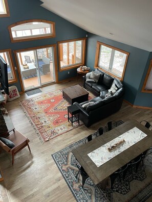 Open concept living room, dining room, kitchen and view of lake