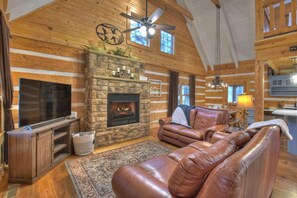 Living room with stone fireplace. Cuddle up and enjoy a night in.