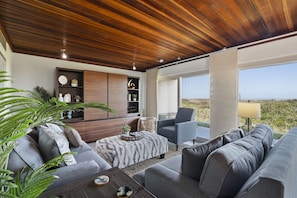 Ample seating featured in the living area, with a flat screen TV in the entertainment center.