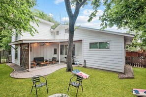 Backyard with firepit, BBQ grill, cornhole, and a fully fenced back yard