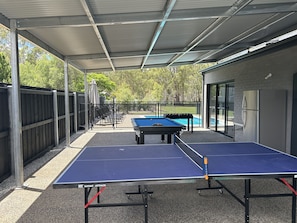 Outdoor games area with table tennis, pool table, darts and foosball table