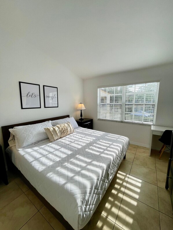 Master bedroom with king size bed and designated workspace