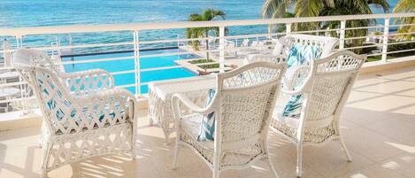 Watch over the pool and the ocean from this classy outside seating are