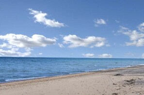 Shallow, swimmable lake.  Miles of walkable sandy beach.