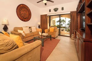 Unwind in the living room with plush suede seating and ocean views