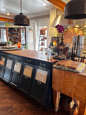 Beautiful kitchen with old store counter as a island.