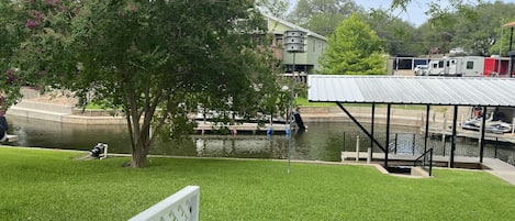 Backyard along channel.  Boat slips in use by owners.