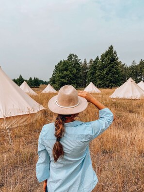 Founder, Kylie, looking out at the tents in our first season in Glacier, 2021.