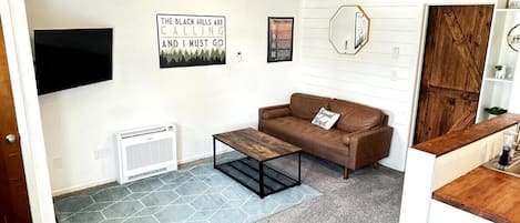 Living area with new carpet, updated furnishings, new AC