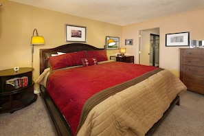 Main level master bedroom with king bed and private bathroom.