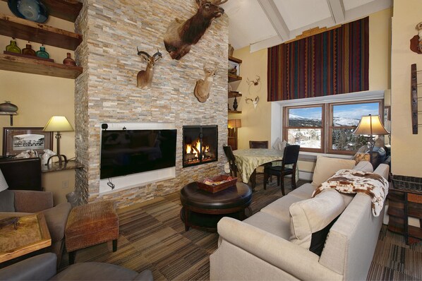Main level living room with gas fireplace.