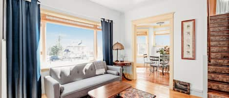 Sun filled living room with two sitting spaces.