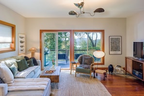 Cozy and inviting, the living room features plush seating, soft lighting, and a smart TV.
