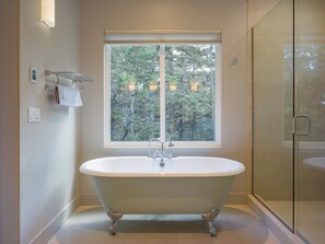 Master Bathroom clawfoot tub with beautiful views of the private forest outside.