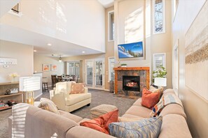 Gorgeous open airy great room with sectional and fireplace
