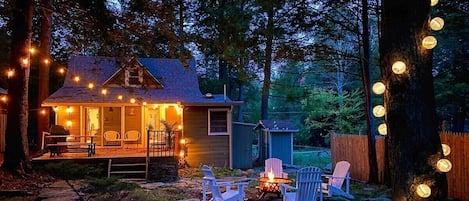 Country nights on the deck or around the fire pit are the best! The deck features a dining table as well as seating area with a sofa and two comfy armchairs. In the double-lot backyard, we have a fire pit and Adirondack chairs.