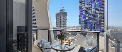 A balcony with a setting and city views.