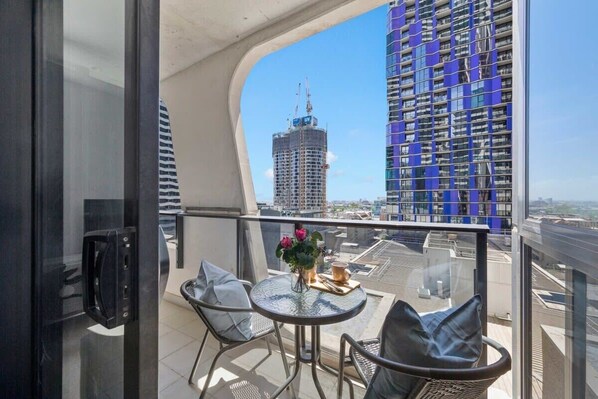 A balcony with a setting and city views.