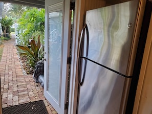 Big Stainless Steel refrigerator and brick walkway to exit