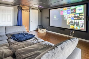 Home theater room with surround sound and comfy lounge couch.
