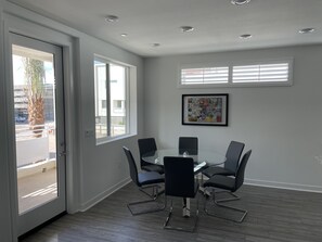 Dining area overlooks patio and green space