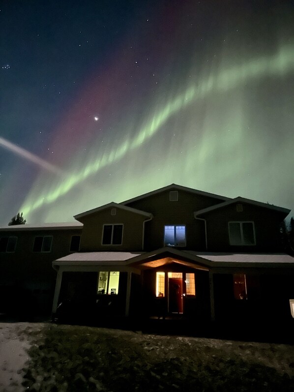 The Aurora Borealis over the house, a planet &  stream of light from the moon