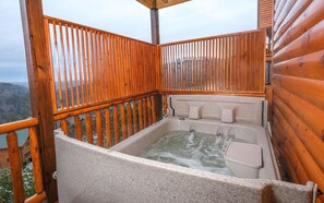 Soak in the outdoor hot tub with stunning views of the Smoky Mountains!
