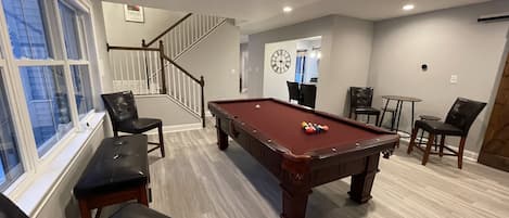 Pool table room with Roku TV and bathroom