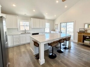 8 stools around the kitchen island - great social spot