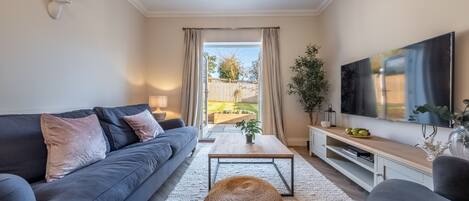 Glimpse, Hunstanton: A comfortable sitting room with patio doors to the garden