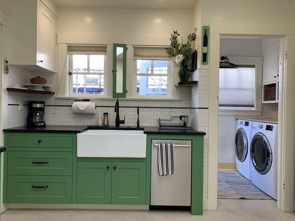 Kitchen sink, dishwasher and laundry room.  Classic charm, modern convenience.