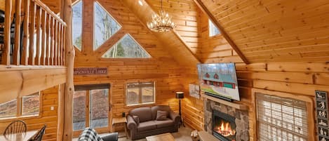 Lodge living room with 75" TV w/ Sonos Sound & gas fireplace.