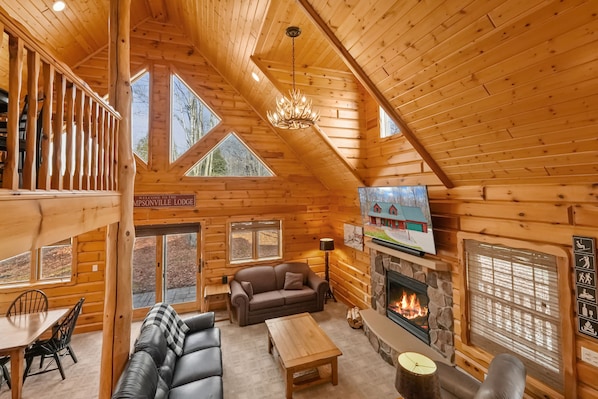 Lodge living room with 75" TV w/ Sonos Sound & gas fireplace.