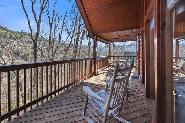 large rear deck with rocking chairs