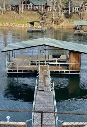 Private deck from the house. Has a boat lift stall.