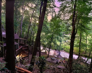 Sunset view from steps to soaking hot tub and rock formation