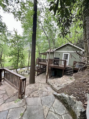 Entrance side of Roho’s Cabin; rock patio and walkway