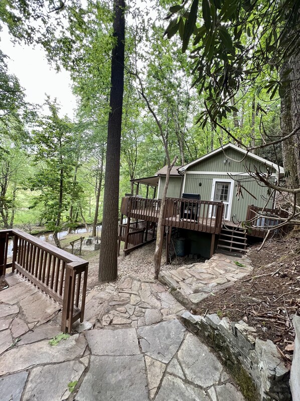 Entrance side of Roho’s Cabin; rock patio and walkway 