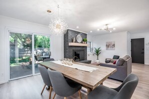 Dining room with funky modern light fixture and beautiful decor. Notice the bench for extra seating!