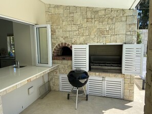 Outdoor BBQ Kitchen with pizza oven; gas grill and charcoal weber gril