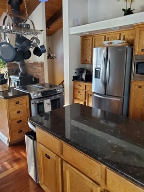 Kitchen with Island Stove. Comes will all the amenities! 