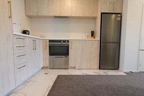 Kitchen - oven, dishdrawer, fridge and stovetop