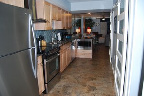 Kitchen - The gourmet kitchen features stainless appliances, and is fully stocked with all items needed for preparing meals during your stay.