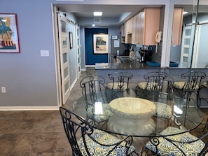 Dining Area - The open dining area features a table with seating for 4, with additional seating provided at the adjacent bar.