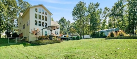 Backyard (fenced) with view of swim spa canopy