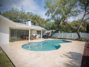 Ivory travertine pool decking and refinished pool tiling detail 
